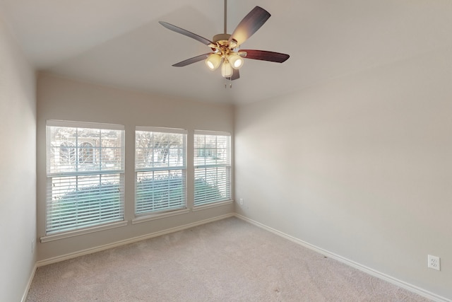 spare room featuring light carpet and ceiling fan