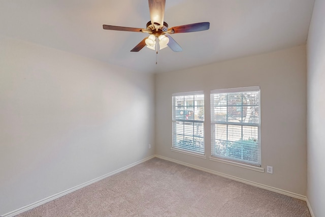 unfurnished room featuring ceiling fan and light carpet