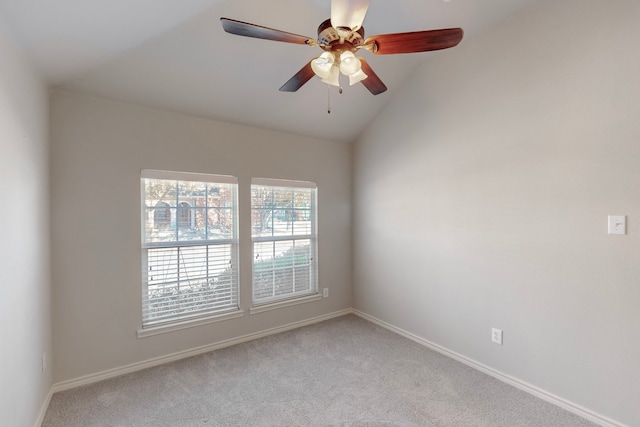 unfurnished room with ceiling fan, lofted ceiling, and light carpet