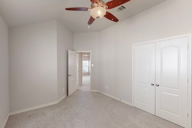 unfurnished bedroom with a closet, ceiling fan, and light colored carpet