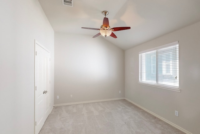 carpeted empty room featuring ceiling fan and lofted ceiling