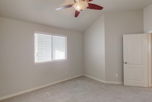 carpeted empty room with vaulted ceiling and ceiling fan