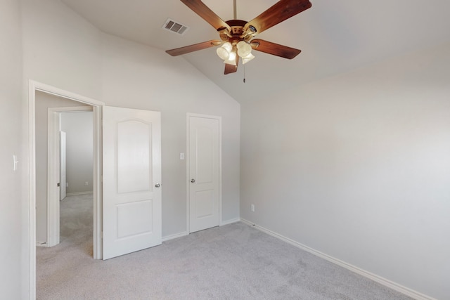 unfurnished bedroom with ceiling fan, high vaulted ceiling, and light carpet