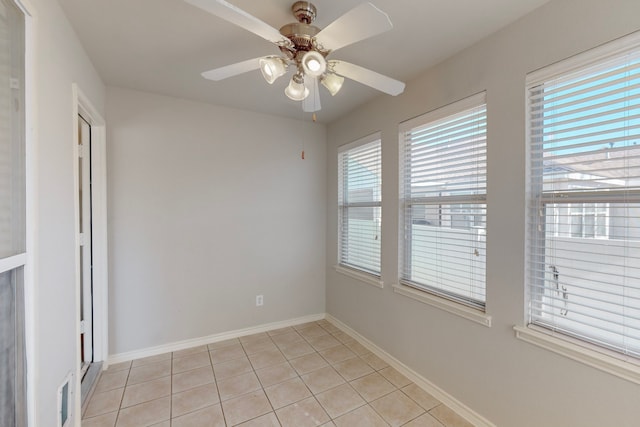 tiled empty room with ceiling fan