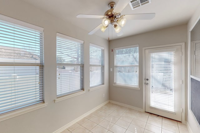 unfurnished sunroom with ceiling fan