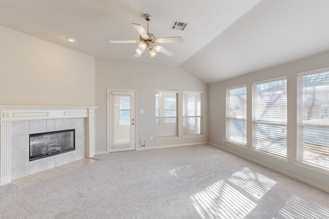 unfurnished living room featuring vaulted ceiling, light colored carpet, and a fireplace