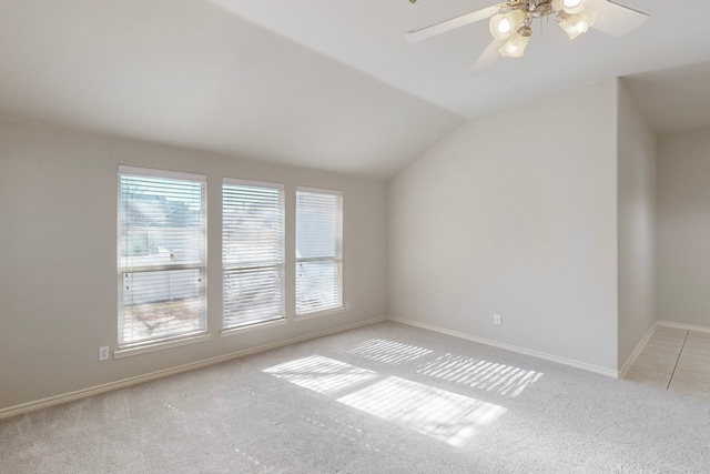 spare room with ceiling fan, light colored carpet, and lofted ceiling