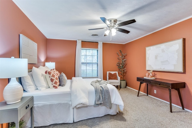 bedroom with crown molding, ceiling fan, and carpet