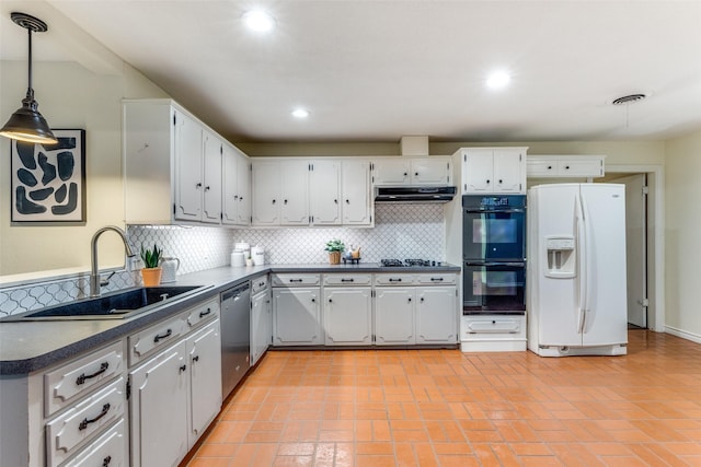 kitchen featuring double oven, sink, hanging light fixtures, white fridge with ice dispenser, and stainless steel dishwasher