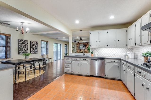 kitchen featuring pendant lighting, stainless steel appliances, decorative backsplash, and white cabinets