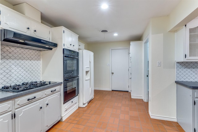 kitchen featuring tasteful backsplash, white cabinets, black double oven, white refrigerator with ice dispenser, and stainless steel gas cooktop