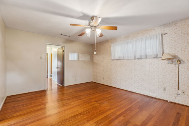 unfurnished room with hardwood / wood-style flooring and ceiling fan