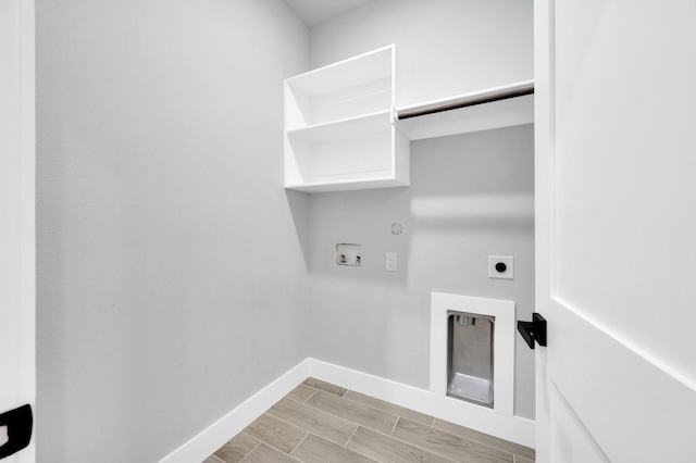 laundry room featuring hookup for an electric dryer, hookup for a gas dryer, washer hookup, laundry area, and baseboards