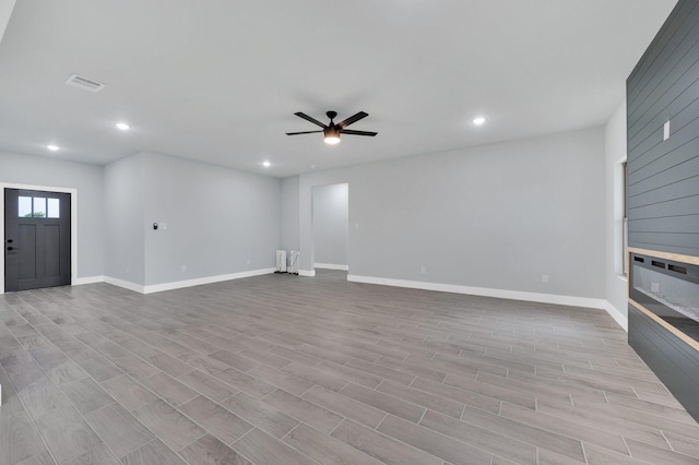 unfurnished living room featuring recessed lighting, visible vents, ceiling fan, and wood finished floors