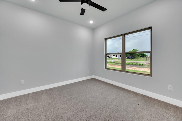 unfurnished room with recessed lighting, ceiling fan, dark carpet, and baseboards