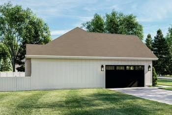 view of side of property with a garage, an outbuilding, and a yard