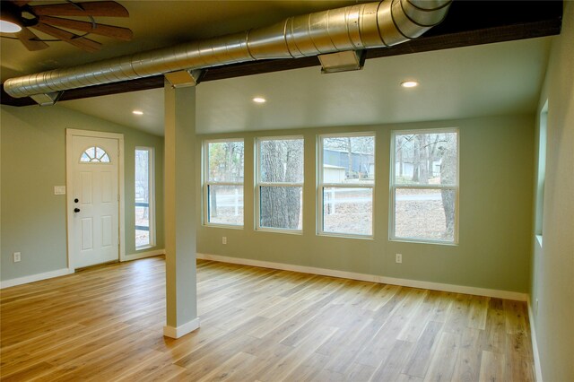 interior space featuring light hardwood / wood-style floors, lofted ceiling, and ceiling fan