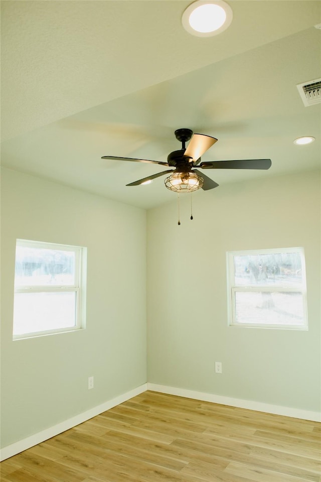 empty room with ceiling fan and light wood-type flooring