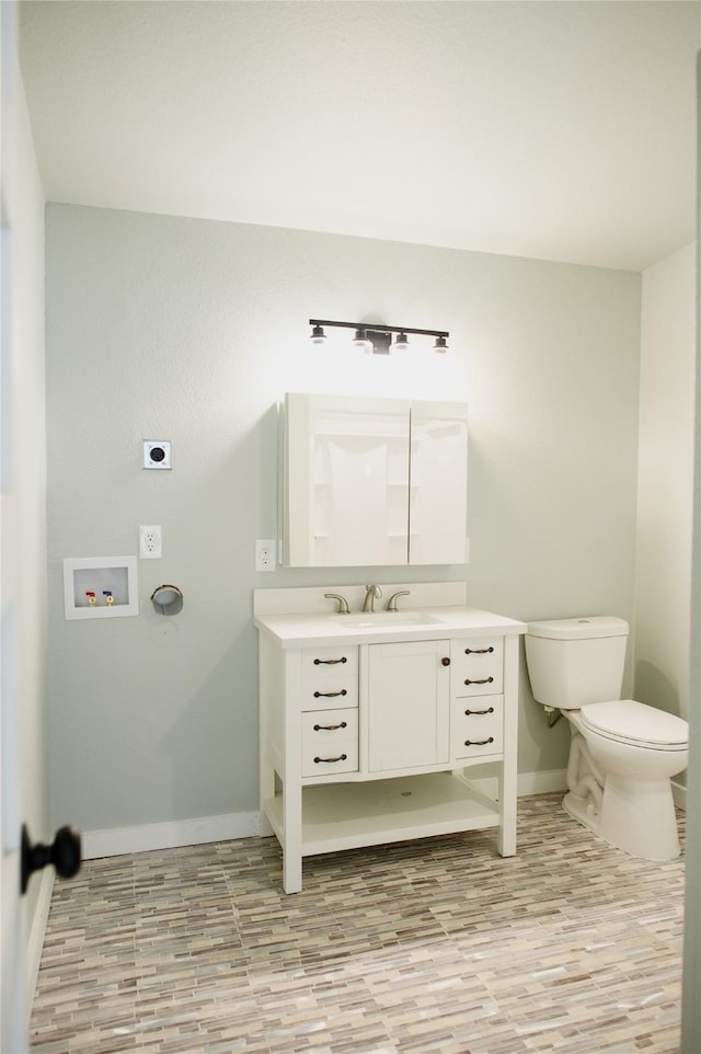 bathroom with hardwood / wood-style flooring, vanity, and toilet