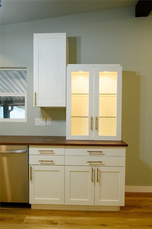 kitchen featuring white cabinetry, stainless steel dishwasher, and light hardwood / wood-style flooring