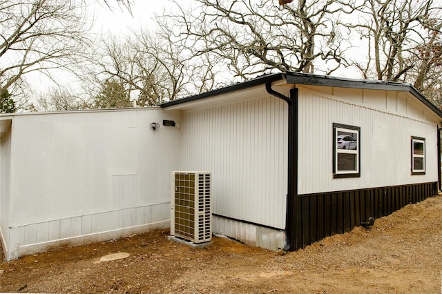 view of side of home with central AC unit