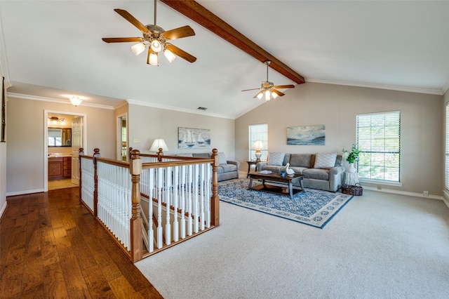 living room featuring dark wood-type flooring, vaulted ceiling with beams, and ornamental molding