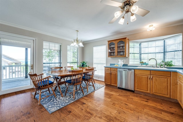 kitchen featuring dishwasher, decorative light fixtures, sink, ornamental molding, and hardwood / wood-style flooring