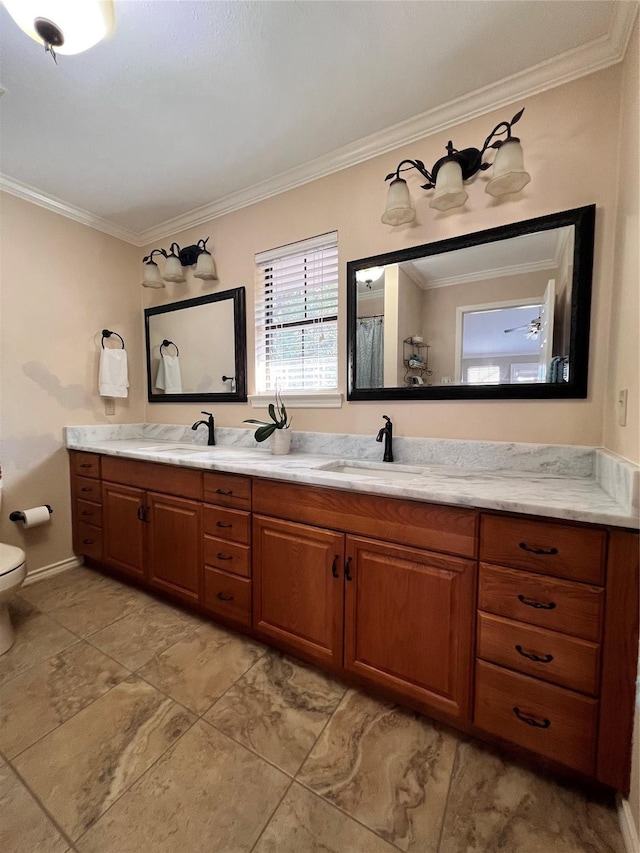 bathroom featuring toilet, vanity, and ornamental molding