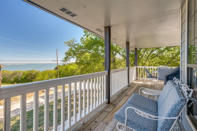 wooden terrace with a water view