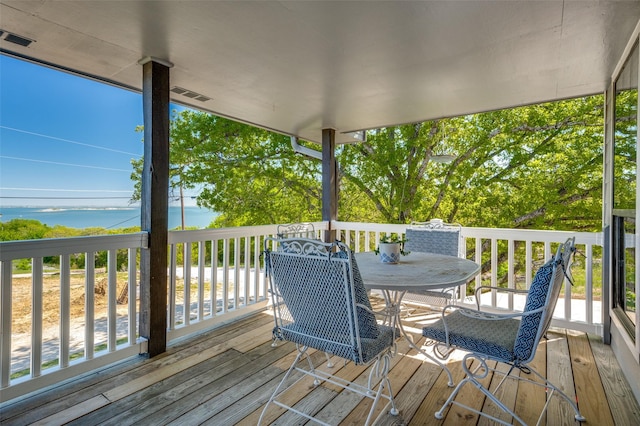 wooden deck featuring a water view