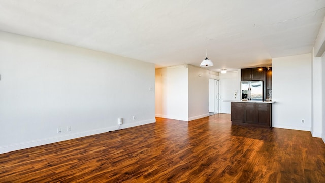 unfurnished living room with dark hardwood / wood-style flooring