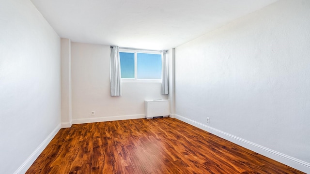 empty room with dark wood-type flooring