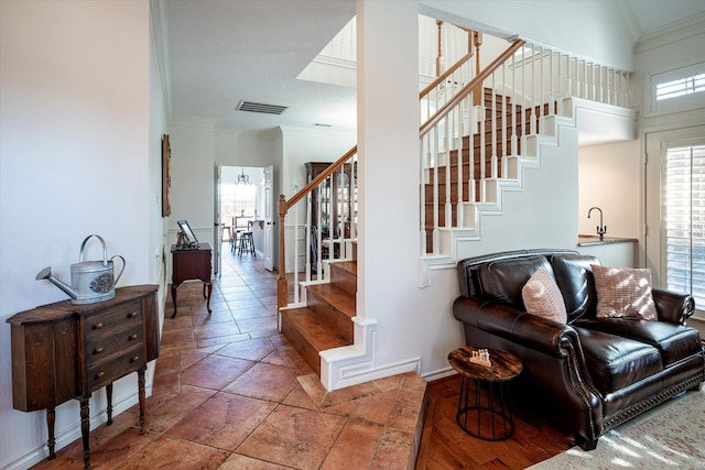 interior space with tile patterned floors and ornamental molding