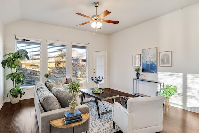 living room featuring lofted ceiling, ceiling fan, wood finished floors, and baseboards