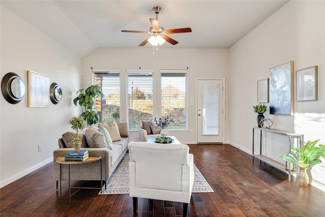 living area with dark wood-style floors, lofted ceiling, ceiling fan, and baseboards