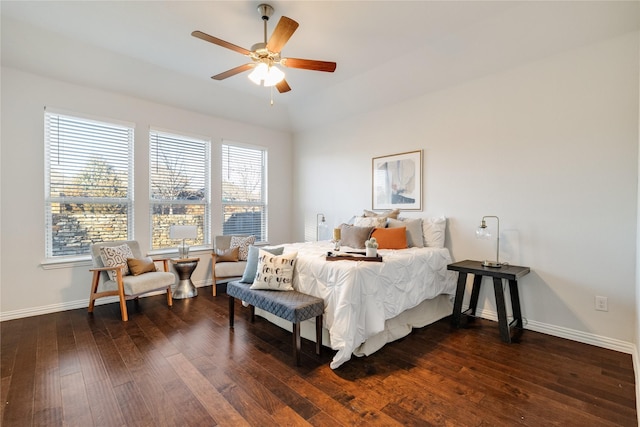 bedroom with dark wood-type flooring, a ceiling fan, and baseboards