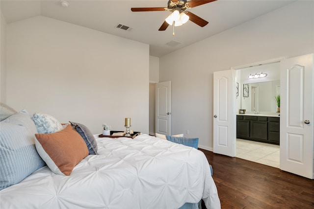 bedroom featuring lofted ceiling, connected bathroom, sink, ceiling fan, and hardwood / wood-style floors