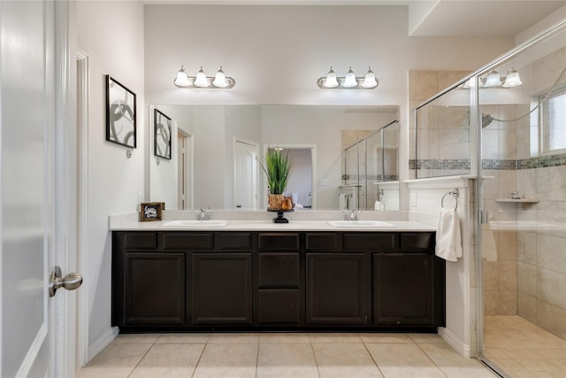 bathroom featuring a shower with door, vanity, and tile patterned floors