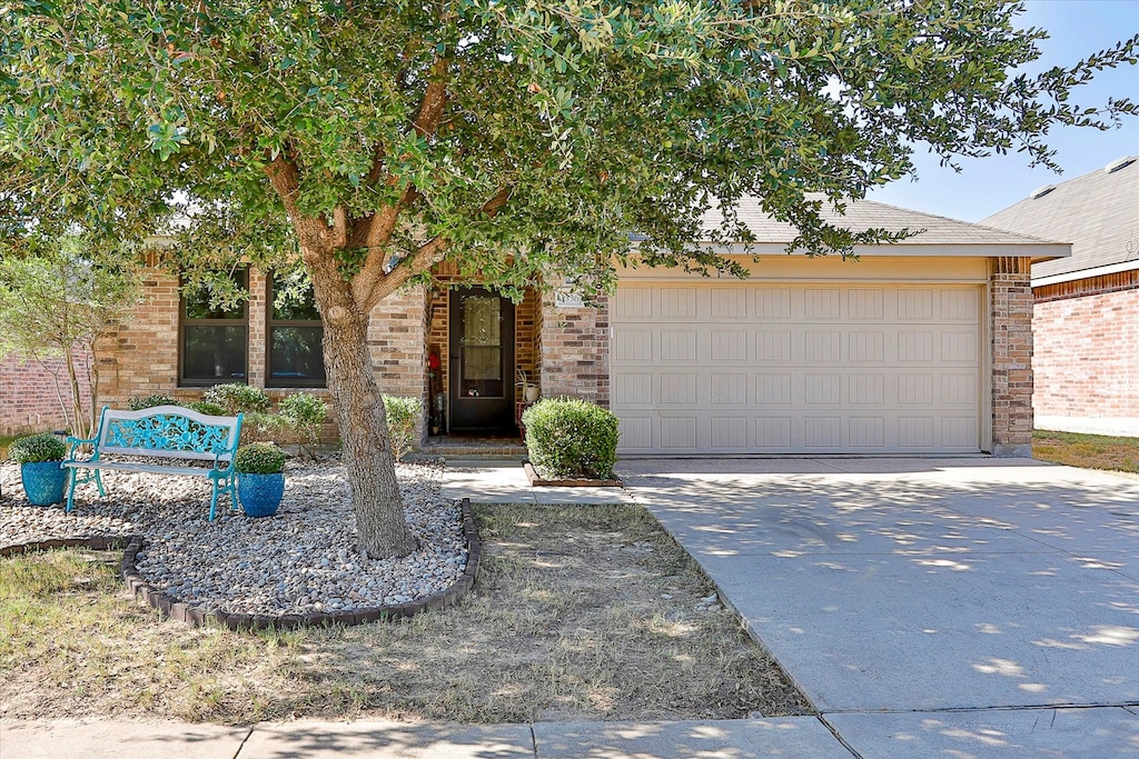 obstructed view of property with a garage