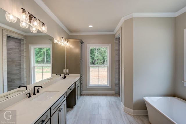 bathroom with a bath, a wealth of natural light, and ornamental molding