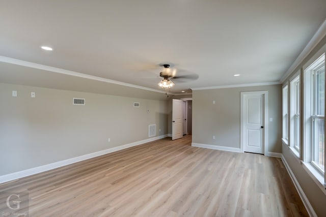 empty room with crown molding, light hardwood / wood-style floors, and ceiling fan