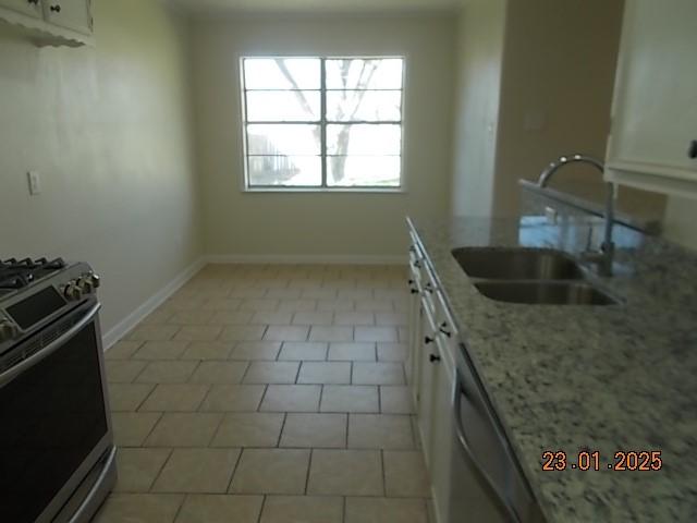 kitchen featuring white cabinetry, sink, stainless steel appliances, and light stone countertops