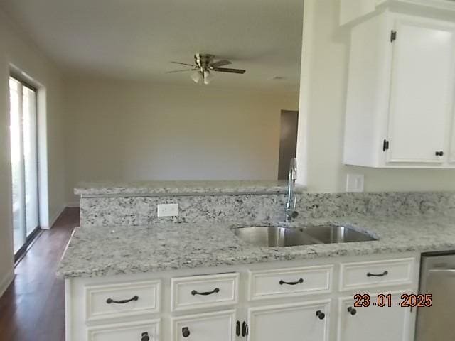 kitchen featuring white cabinetry, light stone countertops, sink, and stainless steel dishwasher