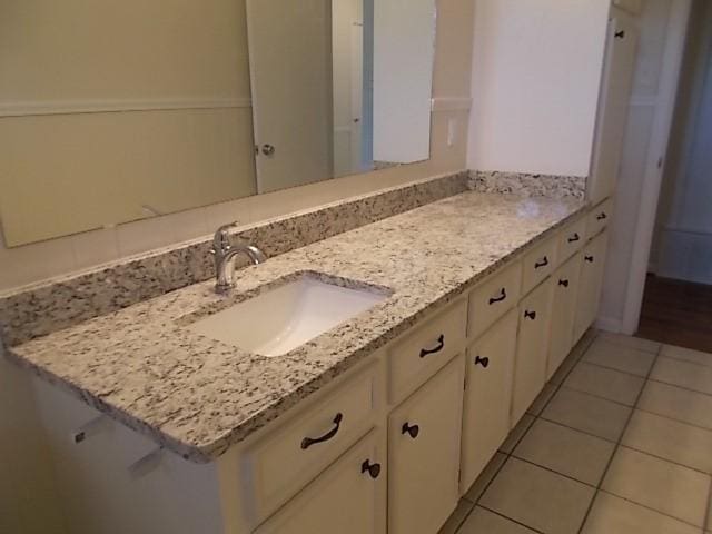 bathroom with tile patterned flooring and vanity