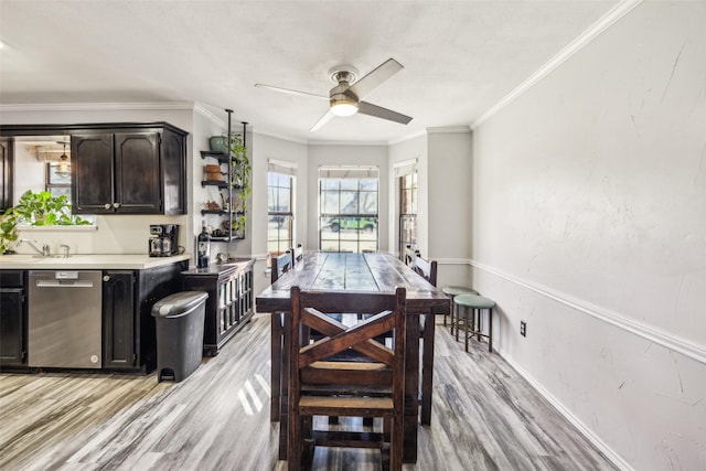 dining space featuring ornamental molding, ceiling fan, and light hardwood / wood-style flooring