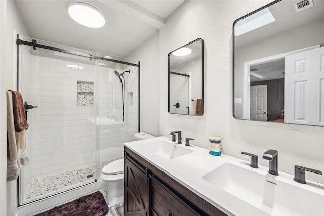 bathroom with a shower with door, vanity, and toilet