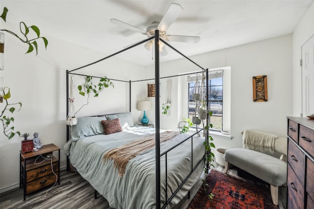 bedroom with dark hardwood / wood-style flooring and ceiling fan