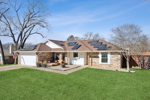 view of front of property with a garage, a front yard, and solar panels