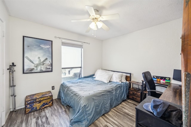 bedroom featuring hardwood / wood-style floors and ceiling fan