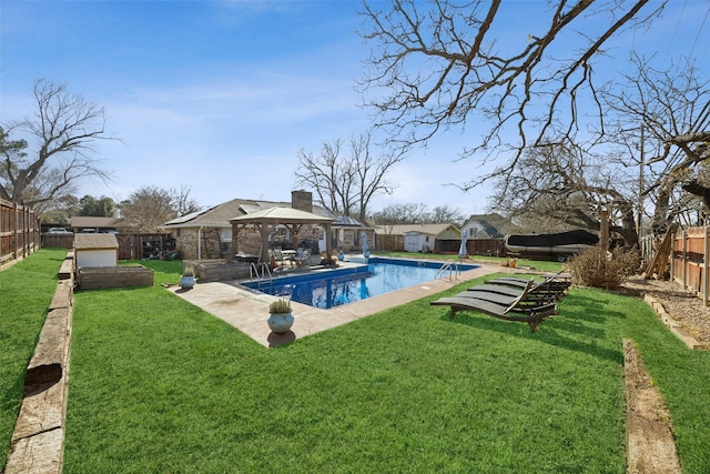 view of pool featuring a gazebo, a storage shed, and a yard